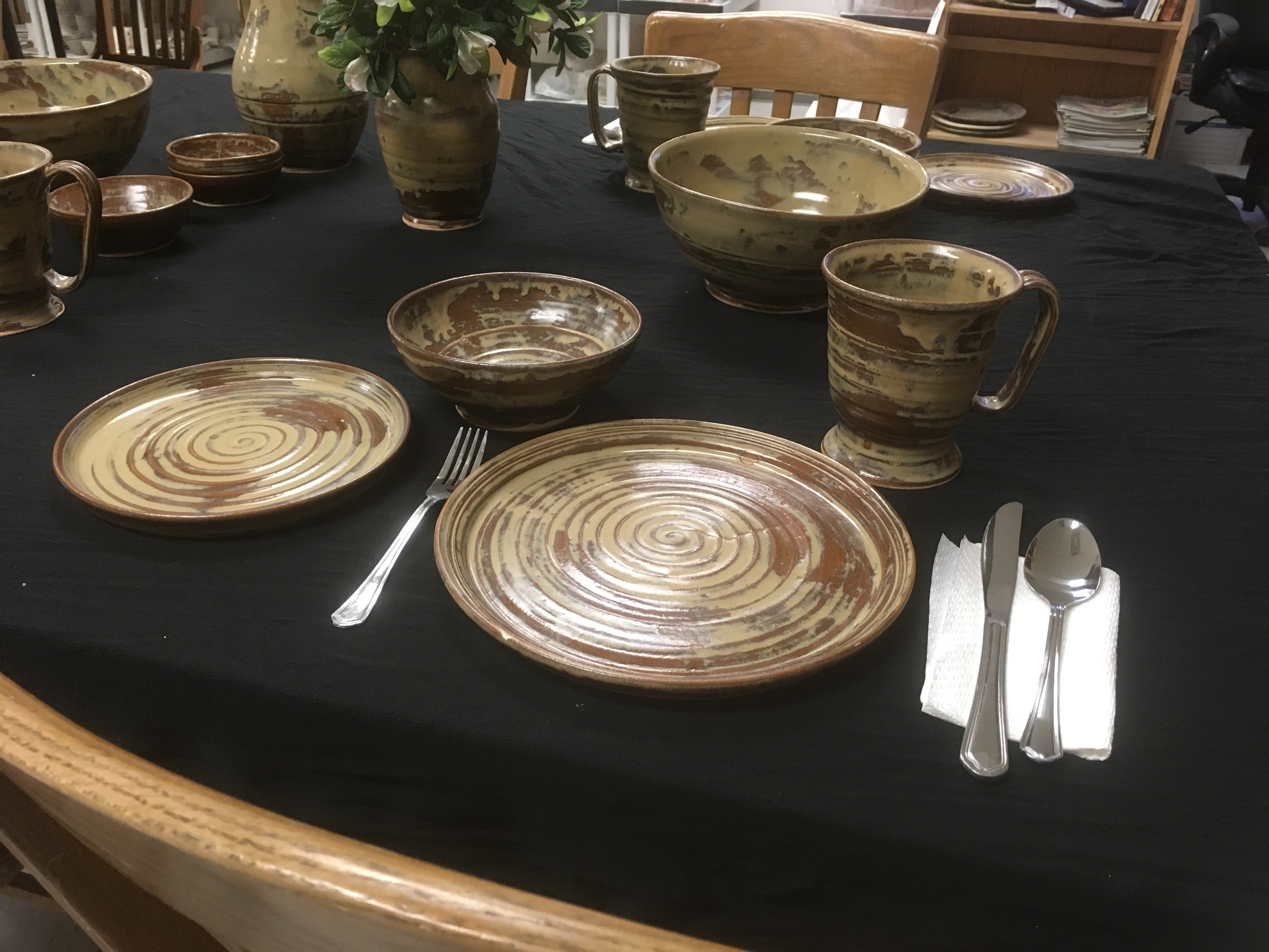 A table set with handmade ceramic dinnerware plates
